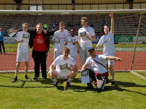 Ein Team in weißen Trikots steht im Tor.
