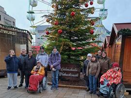 Gruppenfoto vor einem geschmückten Tannenbaum.