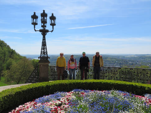Personen vor einem Geländer mit tollem Panorama im Hintergrund.