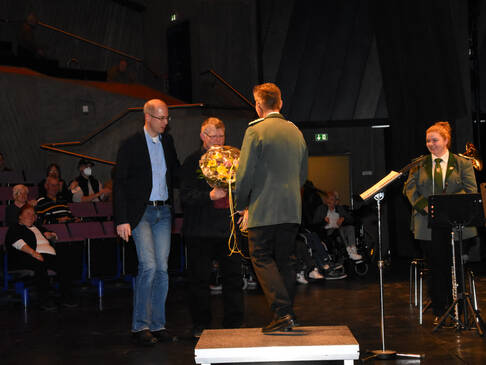 Der Dirigent bekommt Blumen.