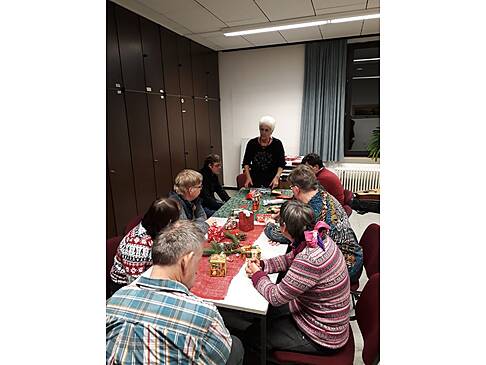 Mehrere Personen sitzen am gedekten Tisch.