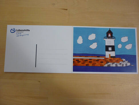 Eine Postkarte mit einem Leuchtturm.